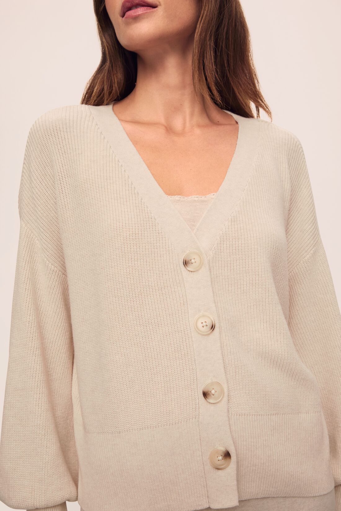 Model is wearing Fine Gauge Sweater Cardigan in Almond Heather