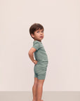 Model is wearing Kids TENCEL™ Modal Unisex Short PJ Set in Eucalyptus/Ivory