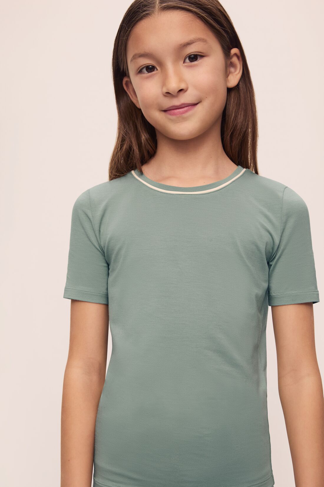 Model is wearing Kids TENCEL™ Modal Unisex Short PJ Set in Eucalyptus/Ivory