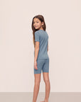 Model is wearing Kids TENCEL™ Modal Unisex Short PJ Set in Faded Denim/Ivory