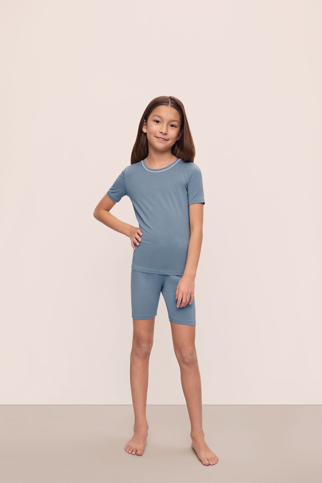 Model is wearing Kids TENCEL™ Modal Unisex Short PJ Set in Faded Denim/Ivory