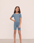 Model is wearing Kids TENCEL™ Modal Unisex Short PJ Set in Faded Denim/Ivory