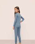 Model is wearing Kids TENCEL™ Modal Unisex Long PJ Set in Faded Denim/Ivory