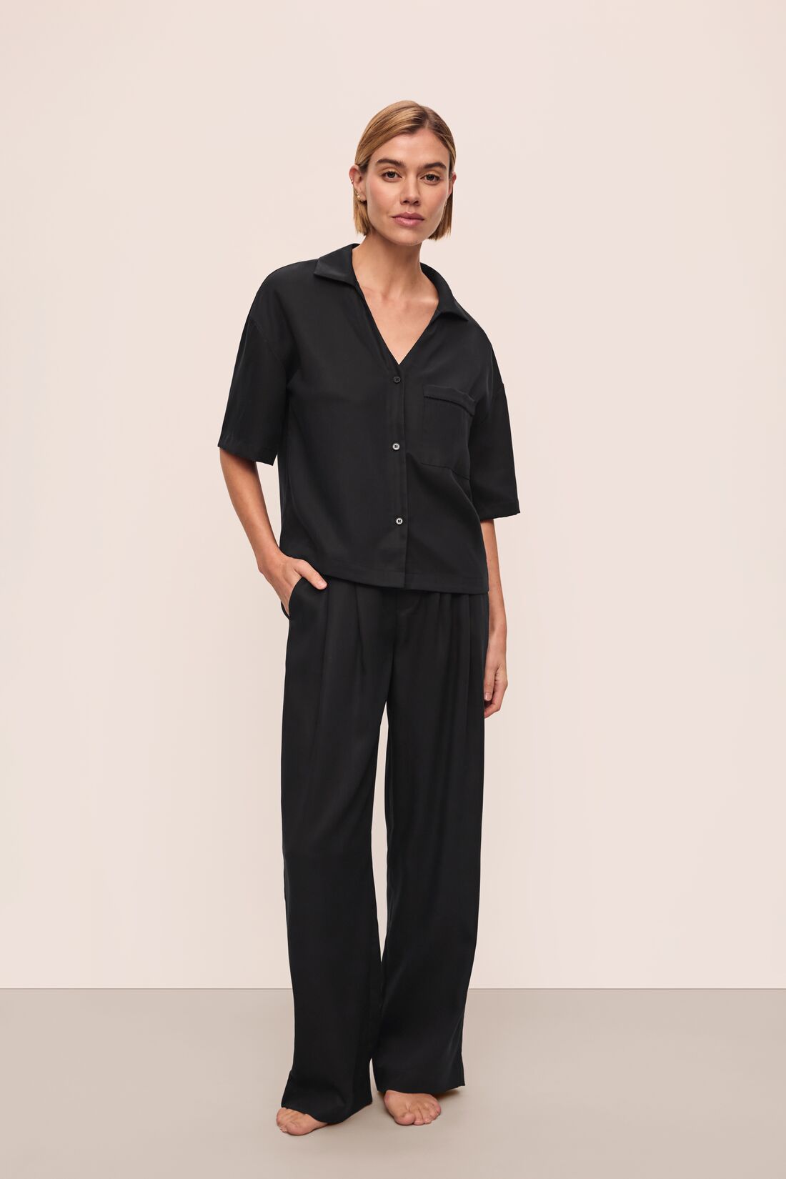 Model wears Tencel Woven Short Sleeve Top in Black