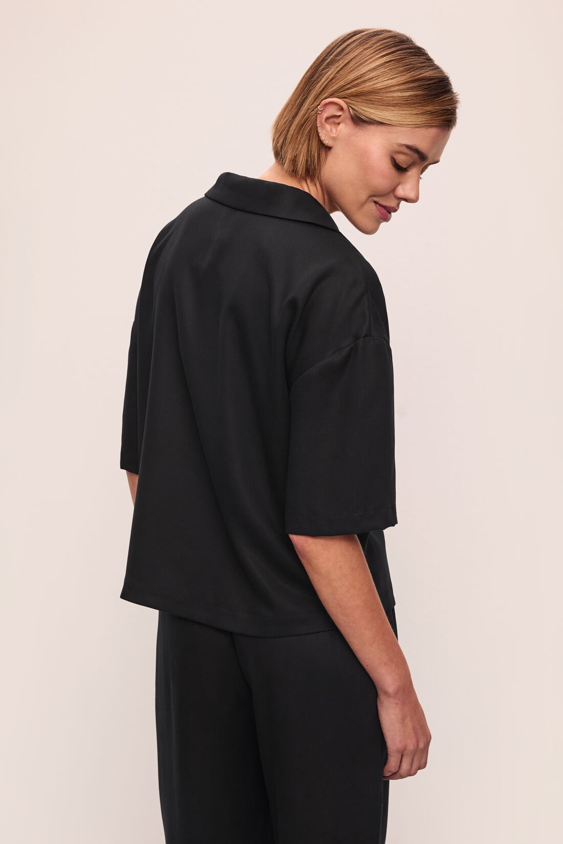 Model wears Tencel Woven Short Sleeve Top in Black