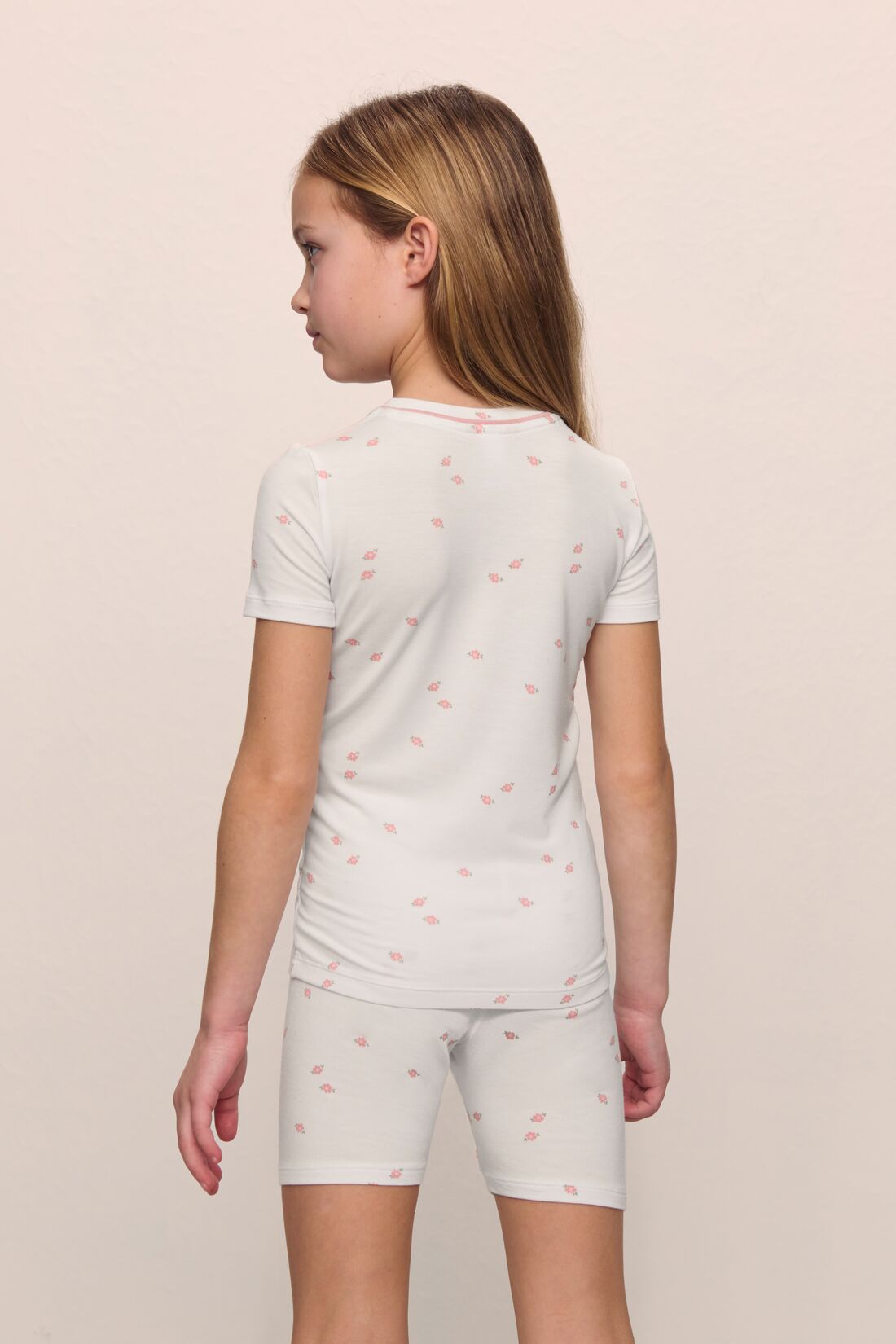 Model is wearing the Kids Printed TENCEL™ Modal Unisex Short PJ Set in Summer Daisy/Pale Mauve
