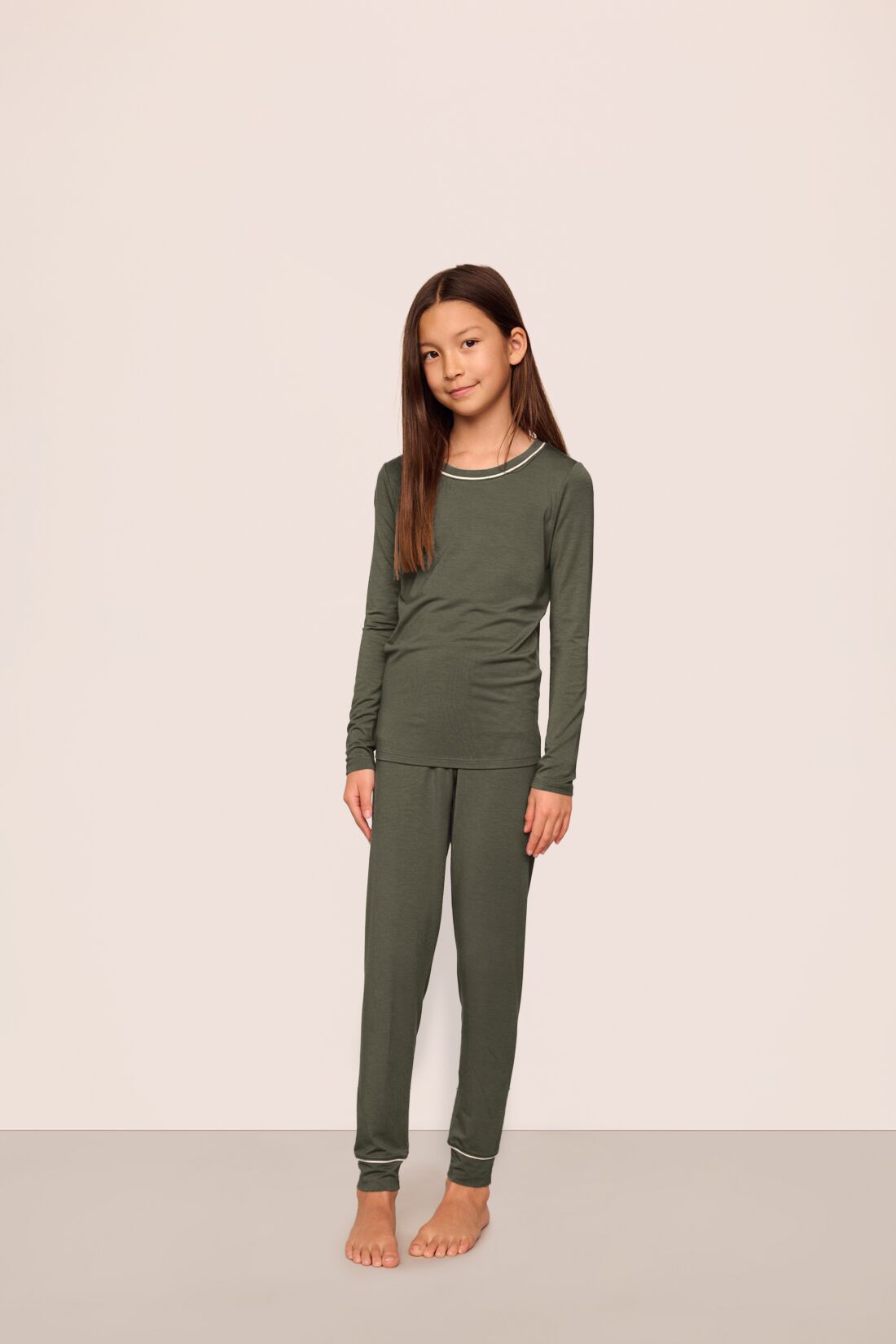 Model is wearing Kids TENCEL™ Modal Unisex Long PJ Set  in Smokey Olive/Ivory