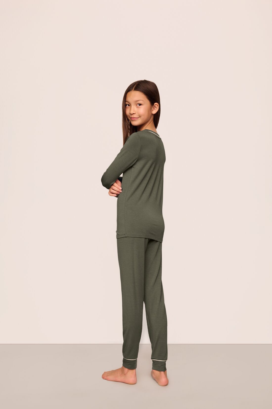 Model is wearing Kids TENCEL™ Modal Unisex Long PJ Set  in Smokey Olive/Ivory
