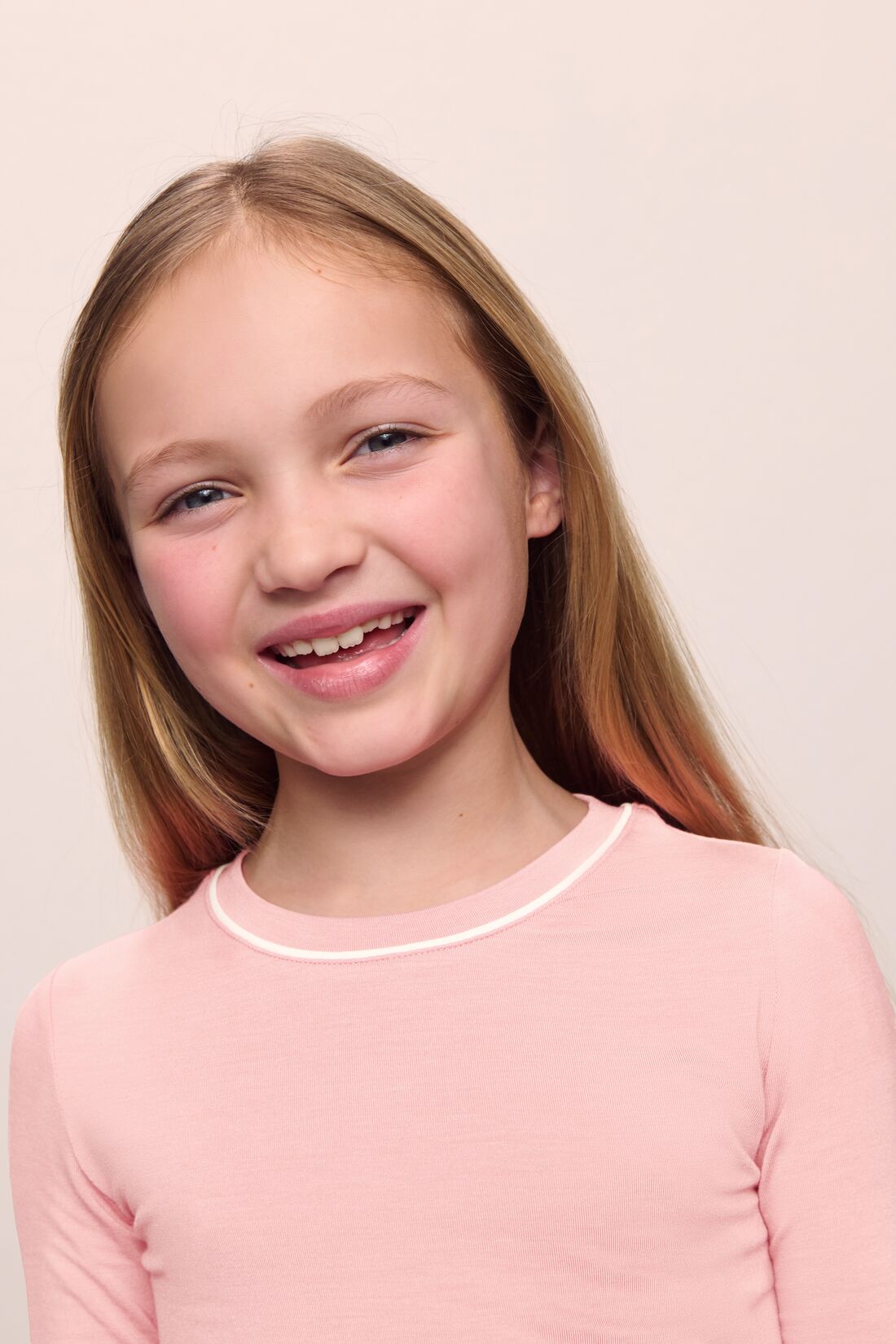 Model is wearing Kids TENCEL™ Modal Unisex Long PJ Set in Silver Pink/Ivory