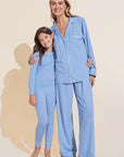 Model wears Kids Printed TENCEL™ Modal Unisex Long PJ Set in Nordic Stripes Vista Blue/Ivory.