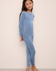 Model wears Kids TENCEL™ Modal Unisex Long PJ Set in wedgewood blue/ivory.