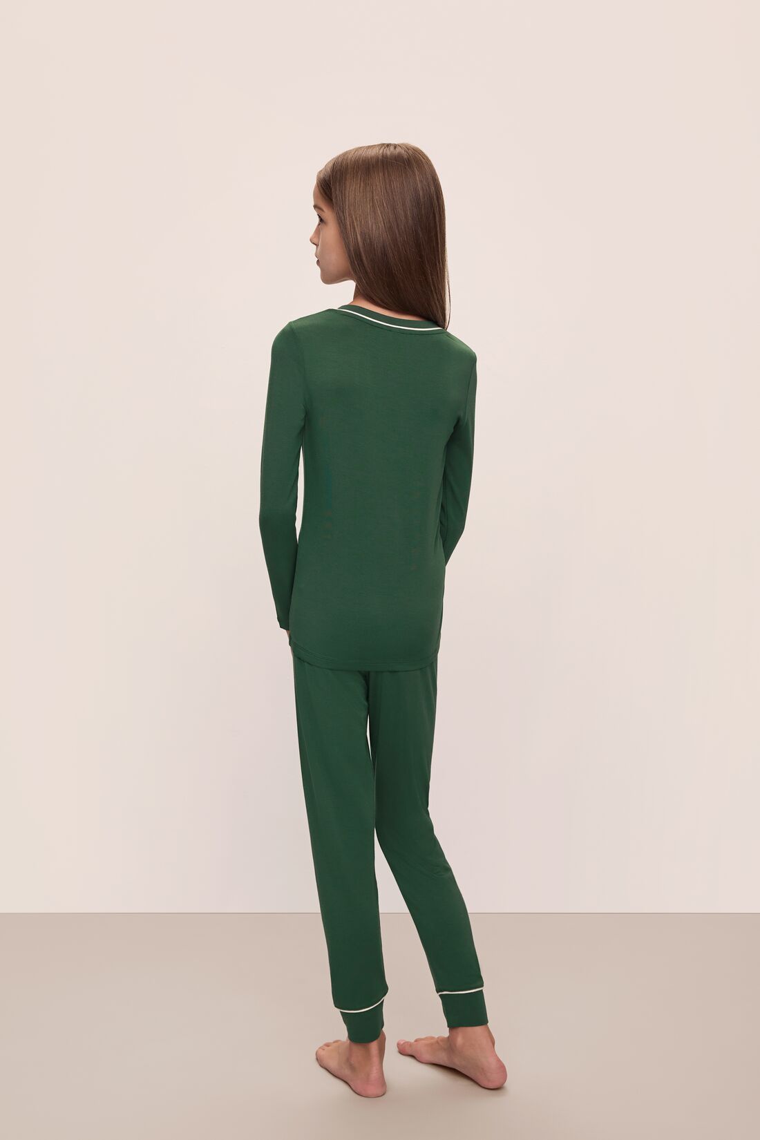 Model wears Kids TENCEL™ Modal Unisex Long PJ Set in Forest Green/Ivory.