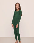 Model wears Kids TENCEL™ Modal Unisex Long PJ Set in Forest Green/Ivory.