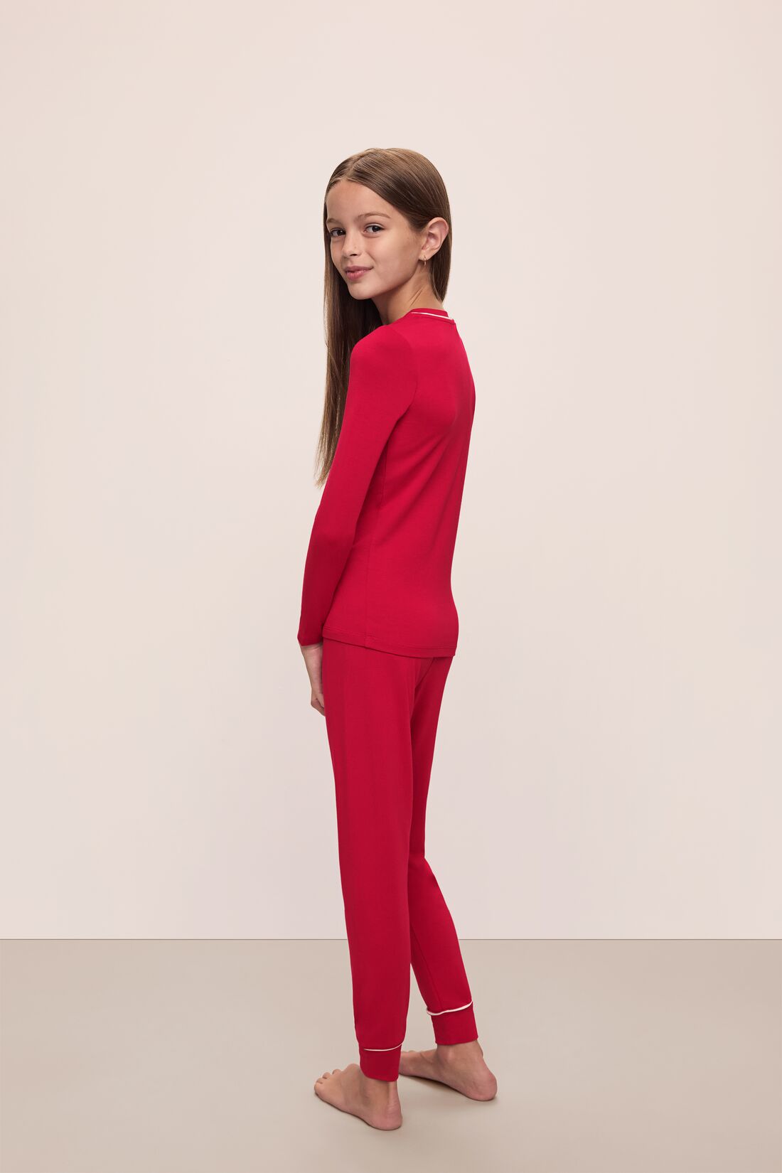 Model wears Kids TENCEL™ Modal Unisex Long PJ Set in Haute Red/Ivory.