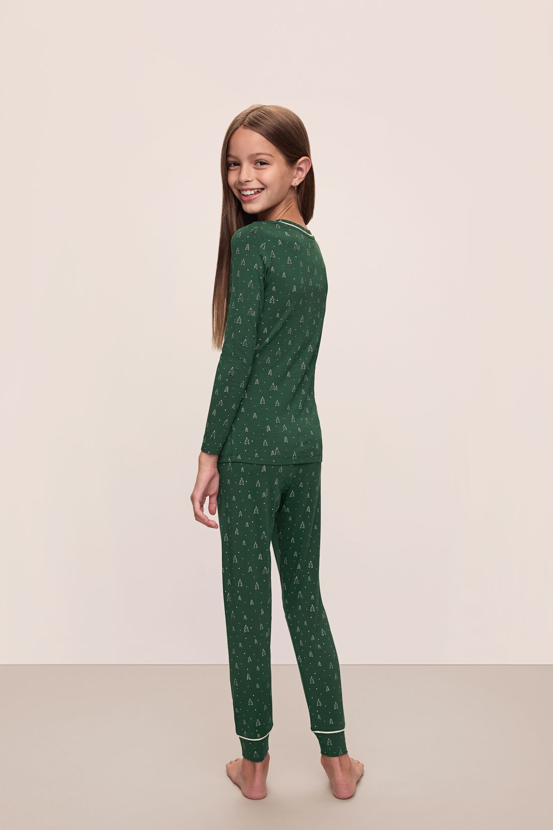 Model wears Kids Printed TENCEL™ Modal Unisex Long PJ Set in Winterpine Forest Green/Ivory.