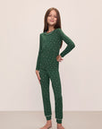 Model wears Kids Printed TENCEL™ Modal Unisex Long PJ Set in Winterpine Forest Green/Ivory.