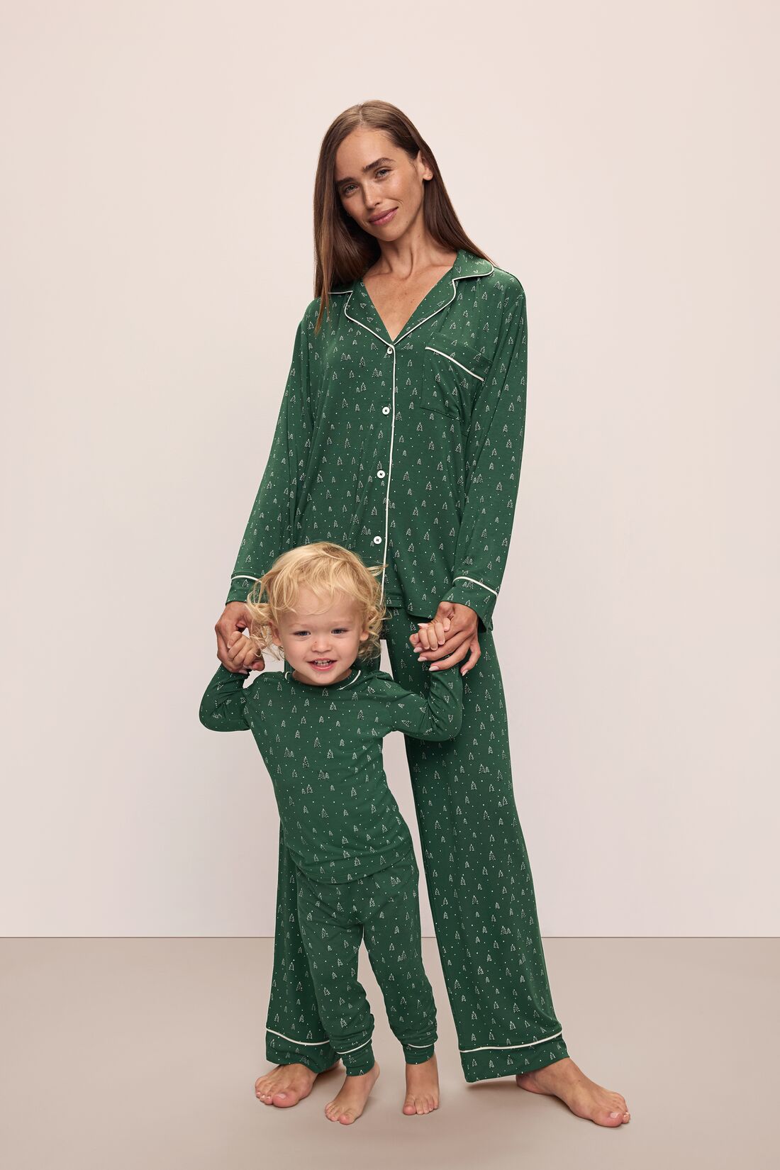 Model wears Kids Printed TENCEL™ Modal Unisex Long PJ Set in Winterpine Forest Green/Ivory.