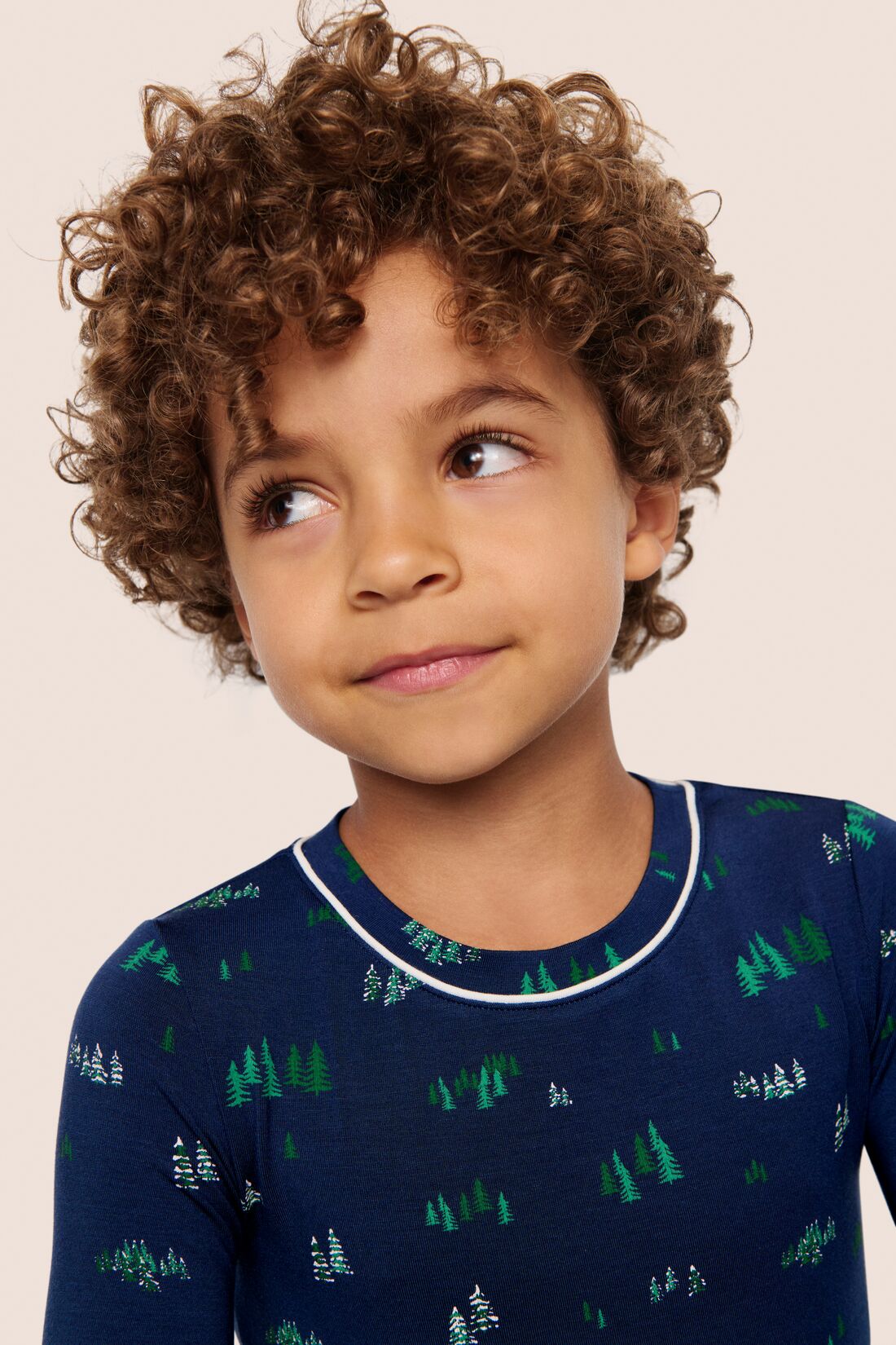 Model is wearing Kids Printed TENCEL™ Modal Unisex Long PJ Set  in Forest Pine Navy/Ivory