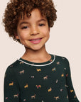 Model is wearing Kids Printed TENCEL™ Modal Unisex Long PJ Set  in Holiday Dogs Pine/Ivory