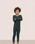 Model is wearing Kids Printed TENCEL™ Modal Unisex Long PJ Set  in Holiday Dogs Pine/Ivory