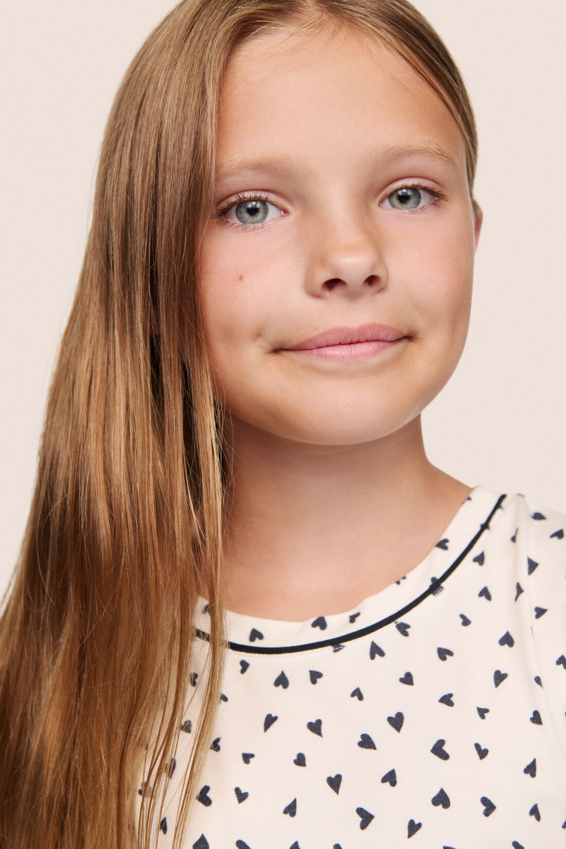 Model is wearing Kids Printed TENCEL™ Modal Unisex Long PJ Set  in Heart To Heart Black/Blk