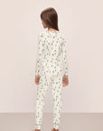 Model wears Kids Printed TENCEL™ Modal Unisex Long PJ Set in Alpine Skier Ivory/Forest Green.