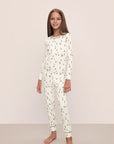 Model wears Kids Printed TENCEL™ Modal Unisex Long PJ Set in Alpine Skier Ivory/Forest Green.