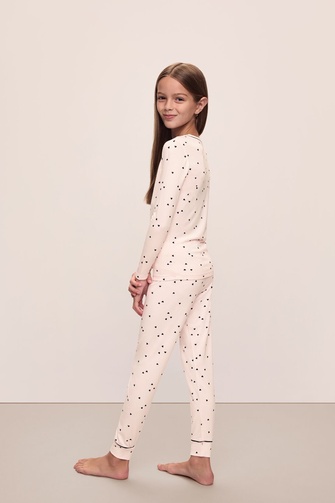 Image of model wearing Kids Printed TENCEL™ Modal Unisex Long PJ Set in Little Heart Sorbet Pink/Black