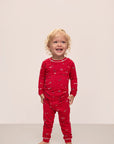 Model wears Kids Printed TENCEL™ Modal Unisex Long PJ Set in Winter Wonderland Haute Red/Ivory.