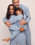 Family image of models in Recycled Boucle Men's Hoodie and Pant, Women's Hoodie and Jogger, and Kid's Hoodie and Jogger Set in Wedgewood