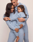 Family image of models in Recycled Boucle Men's Hoodie and Pant, Women's Hoodie and Jogger, and Kid's Hoodie and Jogger Set in Wedgewood