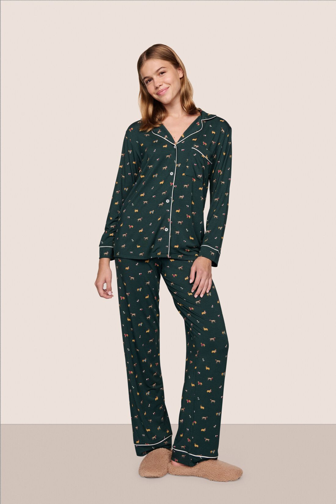 Model is wearing Gisele Printed TENCEL™ Modal Long PJ Set in Holiday Dog Pine/Ivory