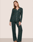 Model is wearing Gisele Printed TENCEL™ Modal Long PJ Set in Holiday Dog Pine/Ivory
