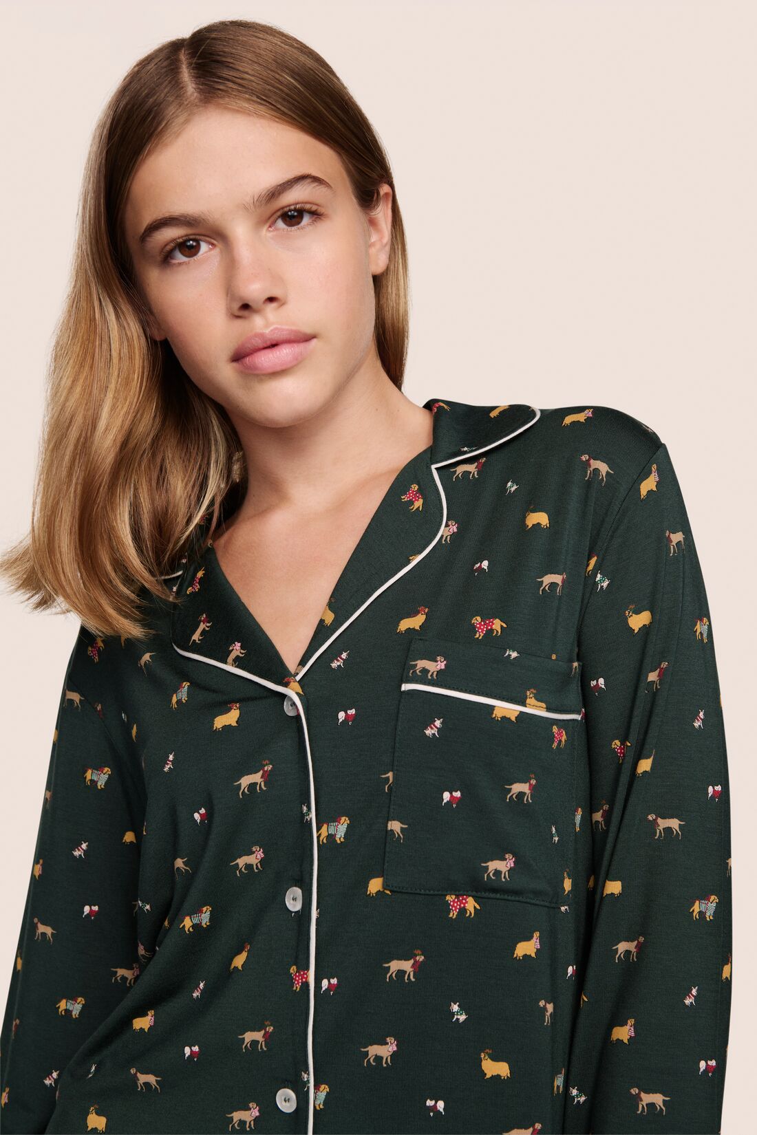 Model is wearing Gisele Printed TENCEL™ Modal Long PJ Set in Holiday Dog Pine/Ivory