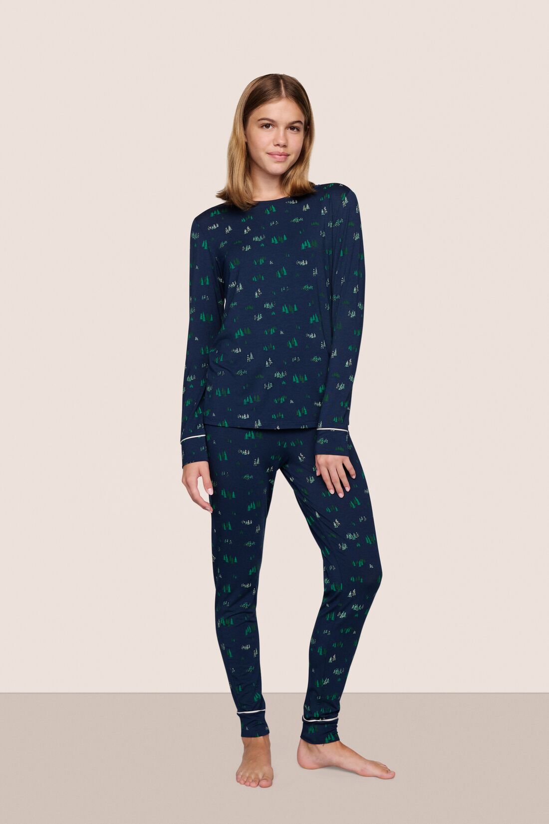 Model is wearing Gisele Printed TENCEL™ Modal Crewneck PJ Set in Forest Pine Navy/Ivory