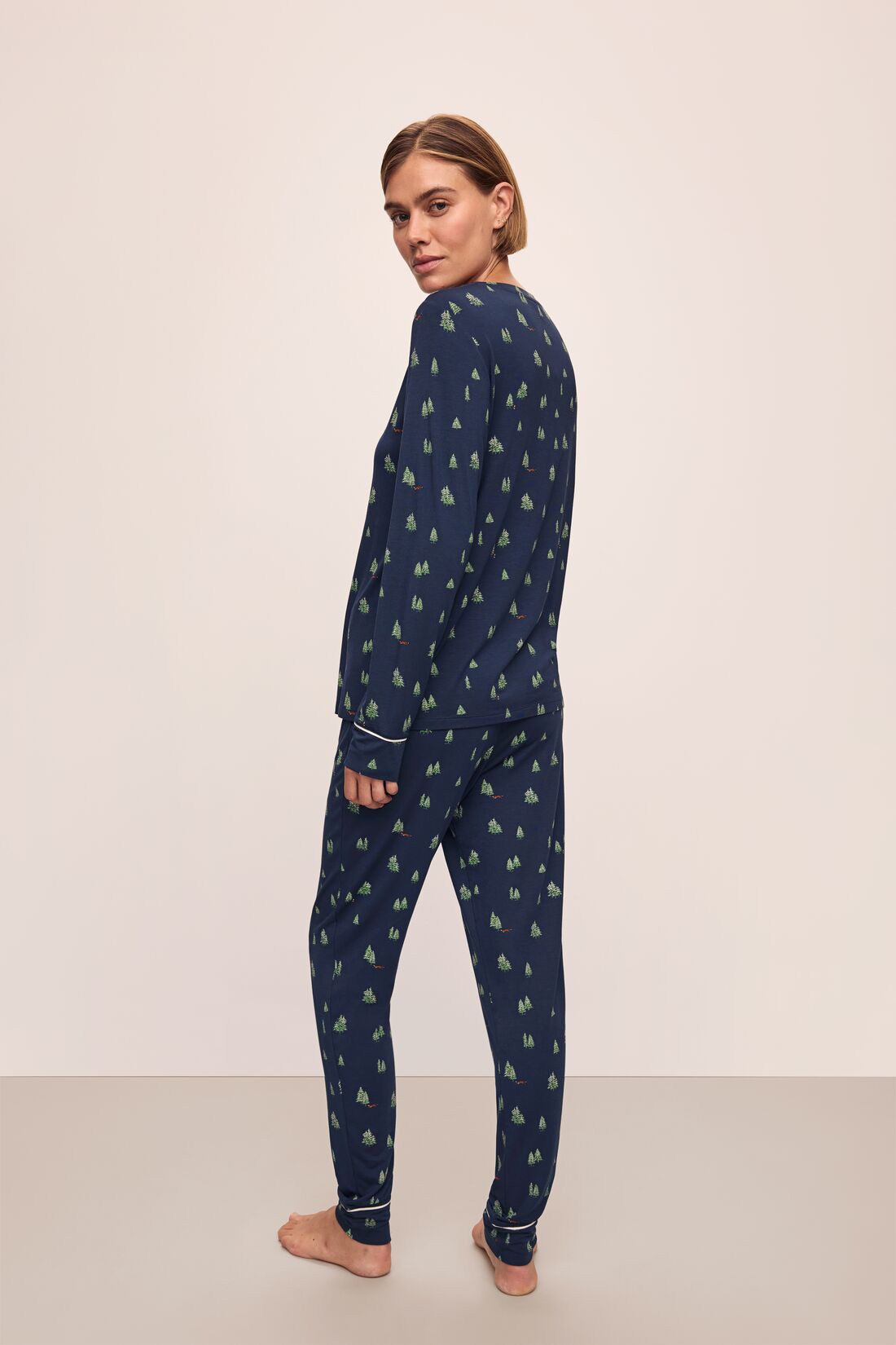 Model wears the Gisele Printed TENCEL™ Modal Crewneck PJ Set in Woodland Pine Navy/Ivory.