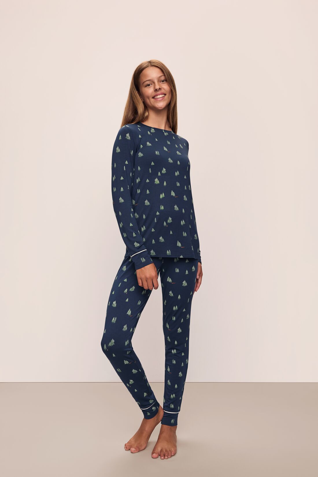 Model wears the Gisele Printed TENCEL™ Modal Crewneck PJ Set in Woodland Pine Navy/Ivory.