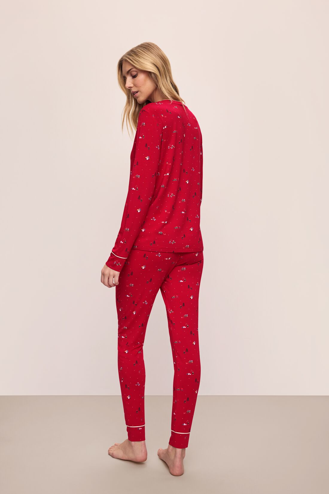 Model wears the Gisele Printed TENCEL™ Modal Crewneck PJ Set in Winter Wonderland Haute Red/Ivory.