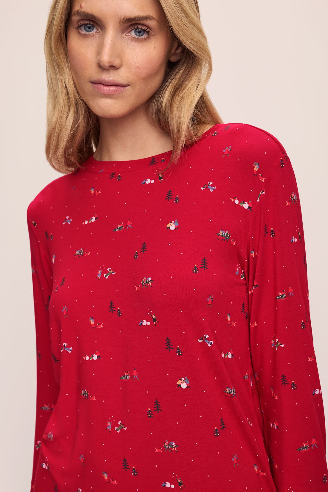 Model wears the Gisele Printed TENCEL™ Modal Crewneck PJ Set in Winter Wonderland Haute Red/Ivory.