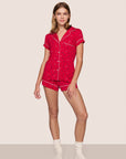 Model is wearing Gisele TENCEL™ Modal Printed Shortie Short PJ Set in Nutcracker Holly Red/Ivory