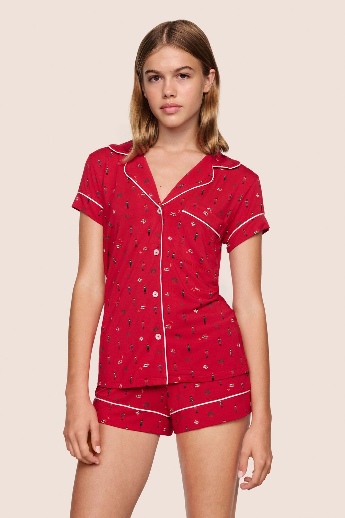 Model is wearing Gisele TENCEL™ Modal Printed Shortie Short PJ Set in Nutcracker Holly Red/Ivory