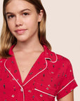 Model is wearing Gisele Printed TENCEL™ Modal Shortie Short PJ Set in Nutcracker Holly Red/Ivory