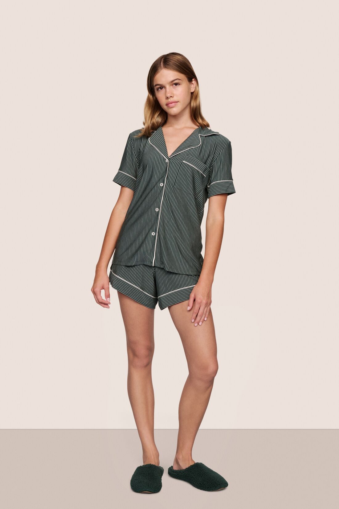 Model is wearing Gisele Printed TENCEL™ Modal Relaxed Short PJ Set  in Duo Stripe Pine/Ivory