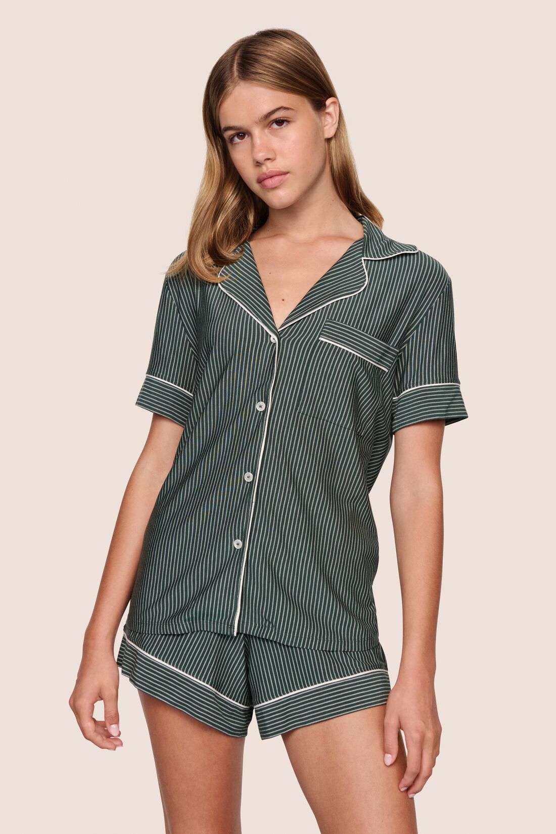 Model is wearing Gisele Printed TENCEL™ Modal Relaxed Short PJ Set  in Duo Stripe Pine/Ivory