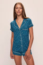 Model wears the Gisele Printed TENCEL™ Modal Shortie Short PJ Set in Festive Lights Sapphire/Ivory.