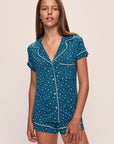 Model wears the Gisele Printed TENCEL™ Modal Shortie Short PJ Set in Festive Lights Sapphire/Ivory.