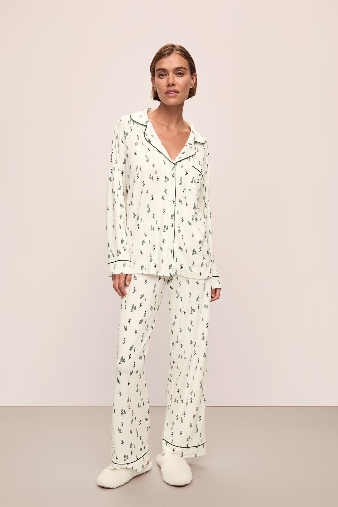 Model wears the Gisele Printed TENCEL™ Modal Long PJ Set in Alpine Skier Ivory/Forest Green.