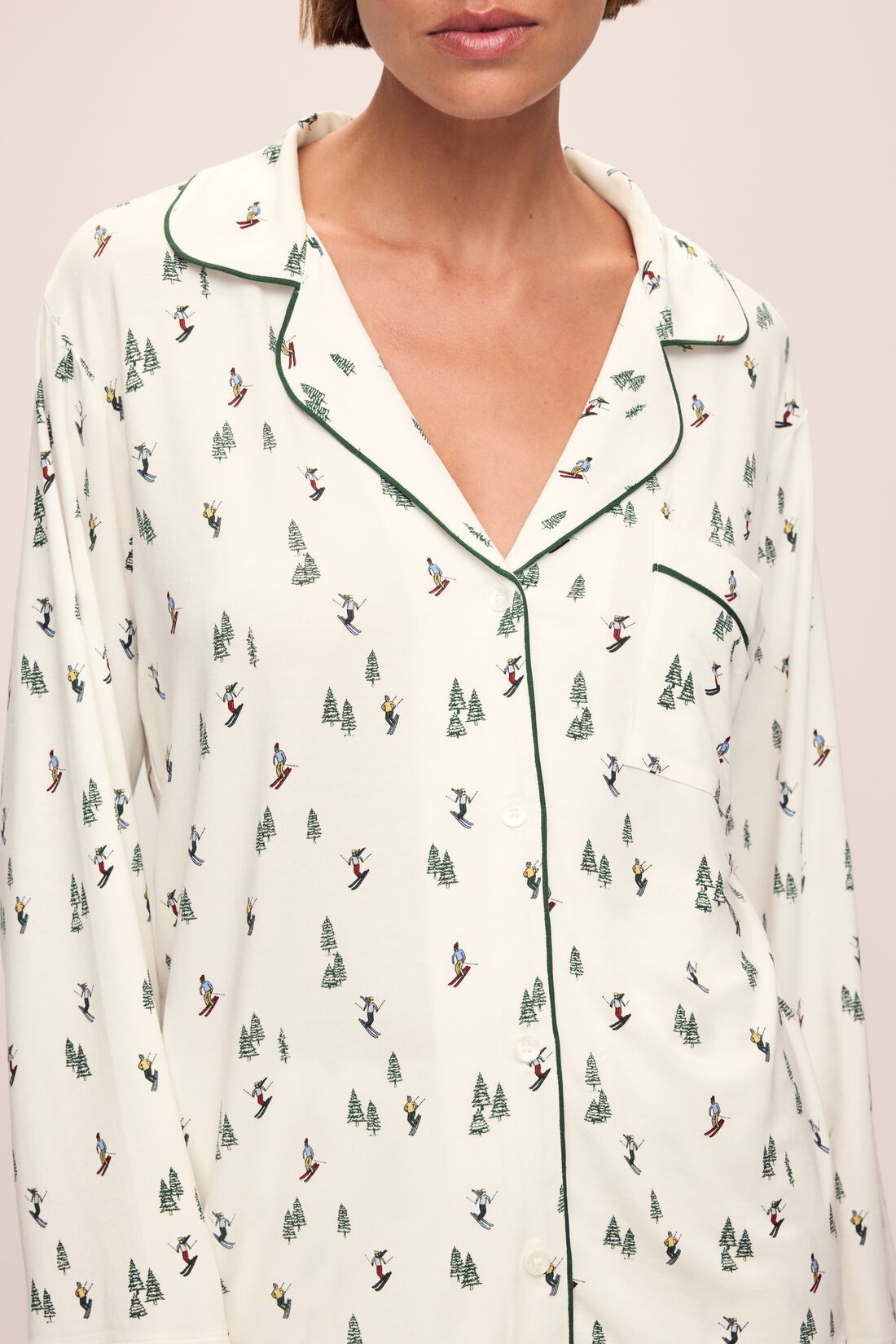 Model wears the Gisele Printed TENCEL™ Modal Long PJ Set in Alpine Skier Ivory/Forest Green.