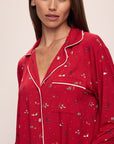 Model wears the Gisele Printed TENCEL™ Modal Long PJ Set in Winter Wonderland Haute Red/Ivory.