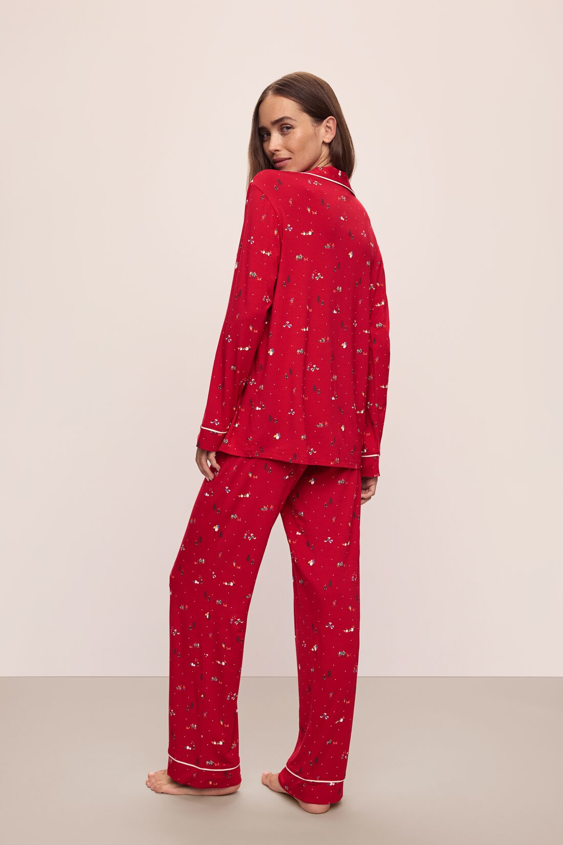 Model wears the Gisele Printed TENCEL™ Modal Long PJ Set in Winter Wonderland Haute Red/Ivory.